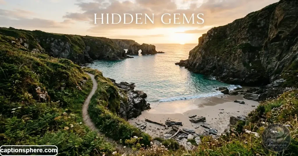 Small secluded beach surrounded by rocky cliffs and clear water.
