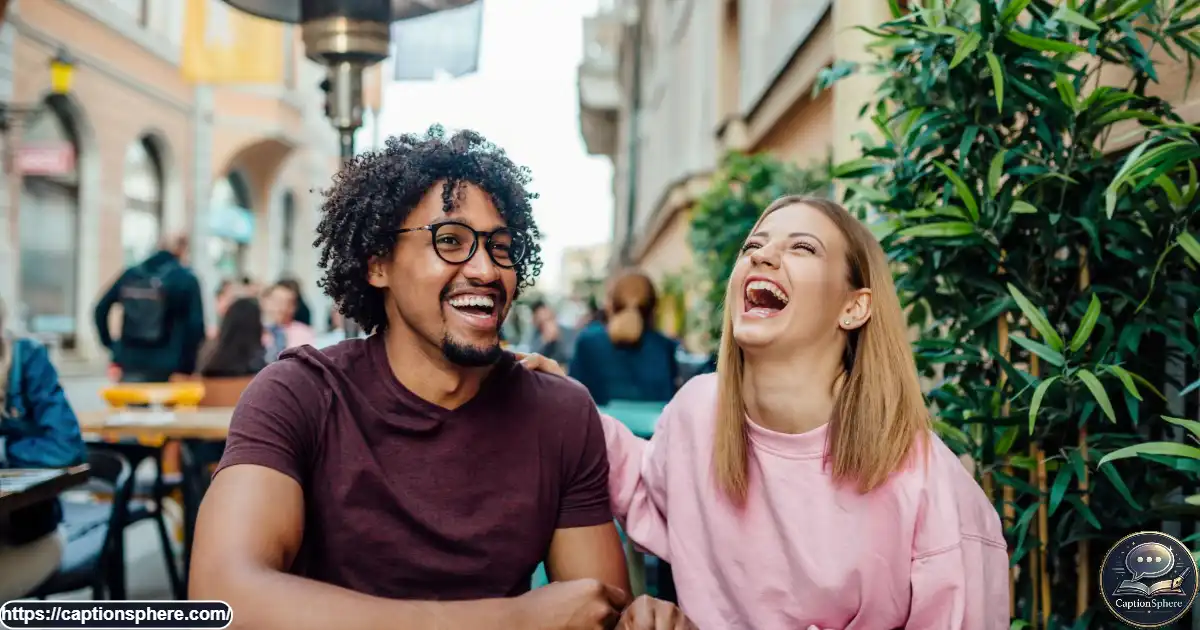 Two friends laughing together during a spontaneous conversation at a cafe.