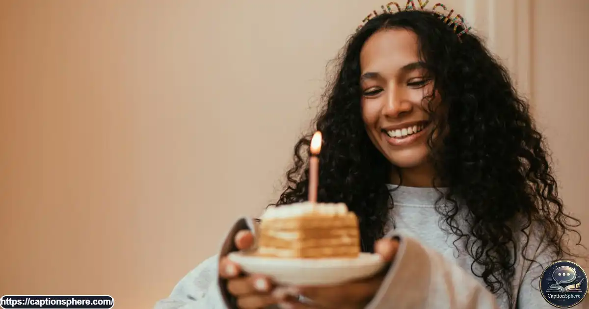 Person celebrating their birthday with a cake and glowing candles.